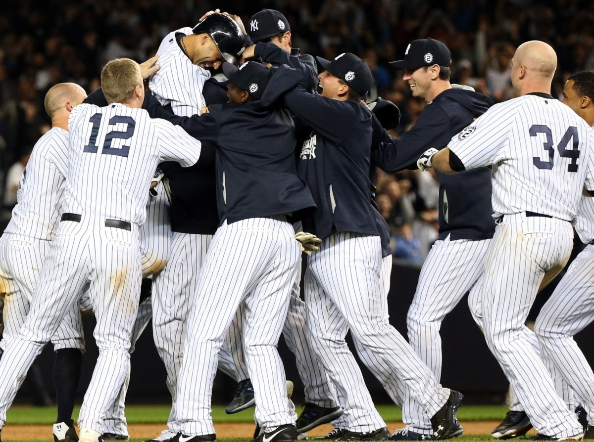 The 2014 New York Yankees celebrate after Derek Jeter 's walk-off single against the Baltimore Orioles in the ninth inning at Yankee Stadium on Sep 25, 2014.