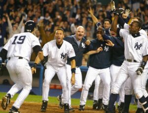 Aaron Boone runs toward his teammates after his walkoff home run in ALCS Game 7 helped the 2003 New York Yankees beat the Red Sox 4-3.