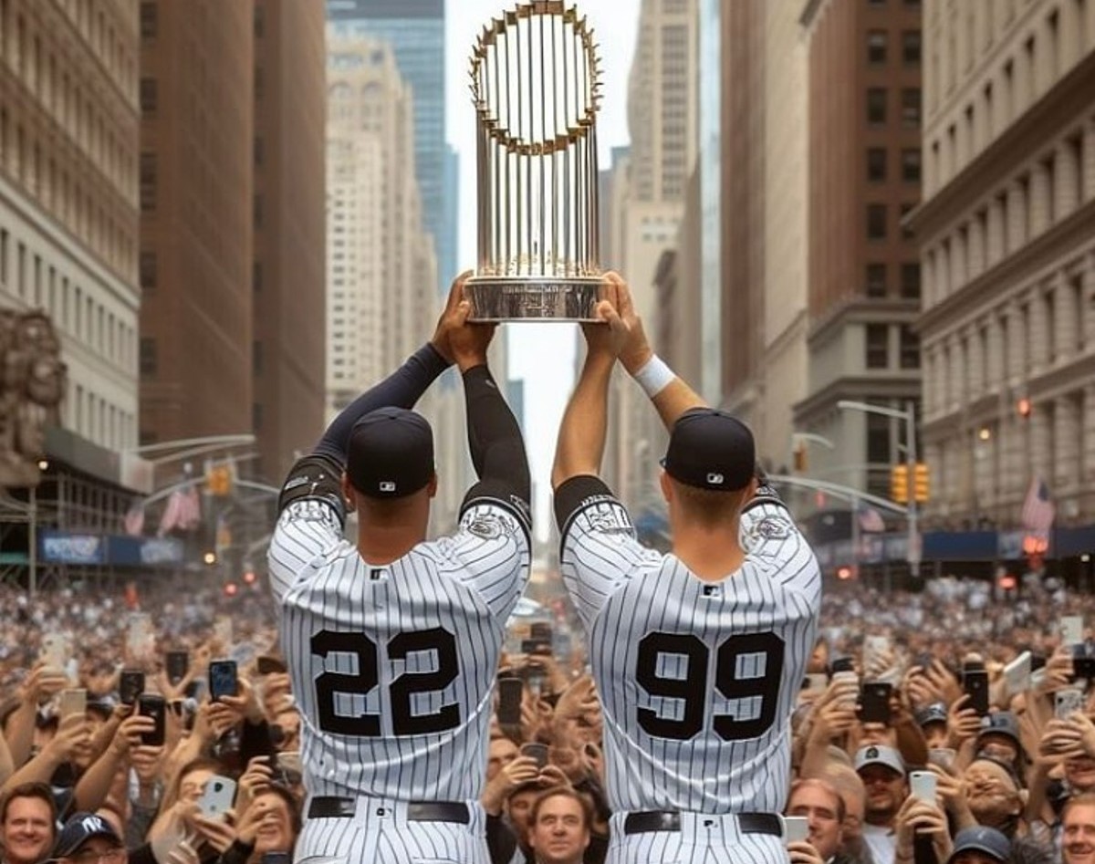An image endition depicting Juan Soto and Aaron Judge presenting the Yankees 2024 championship trophy to fans in New York.