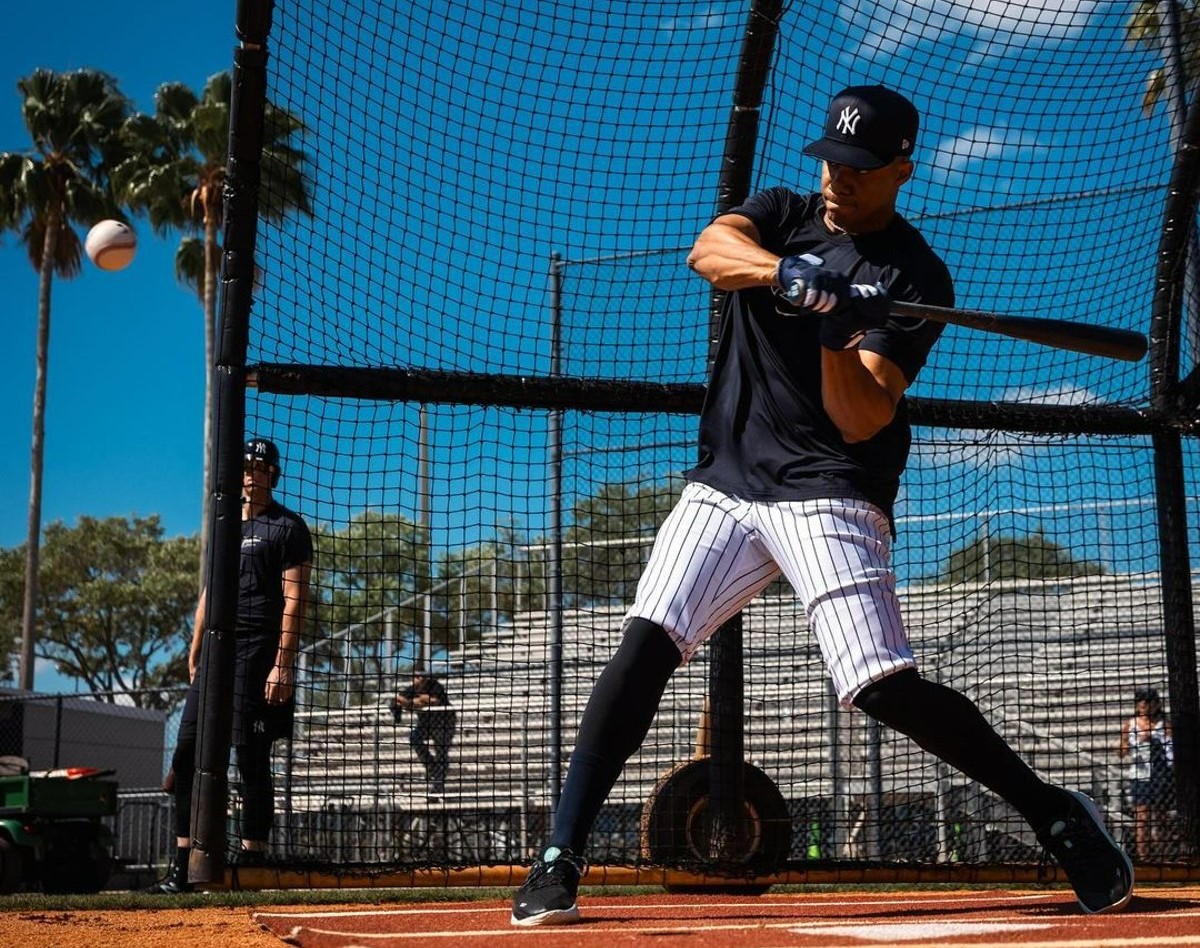 Juan Soto is hitting a pitch during net practice at Yankees' training facility in Tampa in March 2024.
