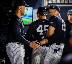 Giancarlo Stanton celebrates with Aaron Judge after his three homers in the Yankees vs. Pirates spring game on March 20, 2024.