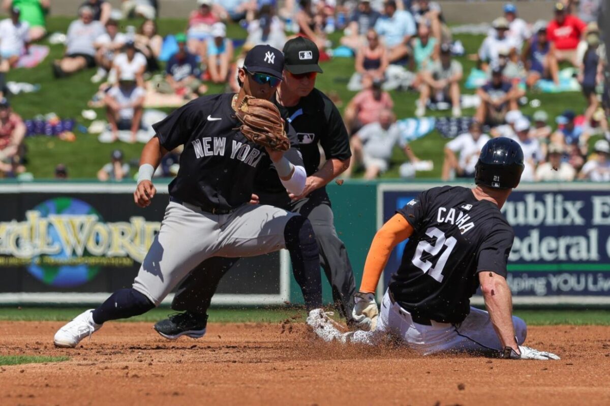 Mar 14, 2024; Lakeland, Florida, USA; Detroit Tigers left fielder Mark Canha (21) slides safe into second against New York Yankees second baseman Gleyber Torres (25) during the second inning at Publix Field at Joker Marchant Stadium. 