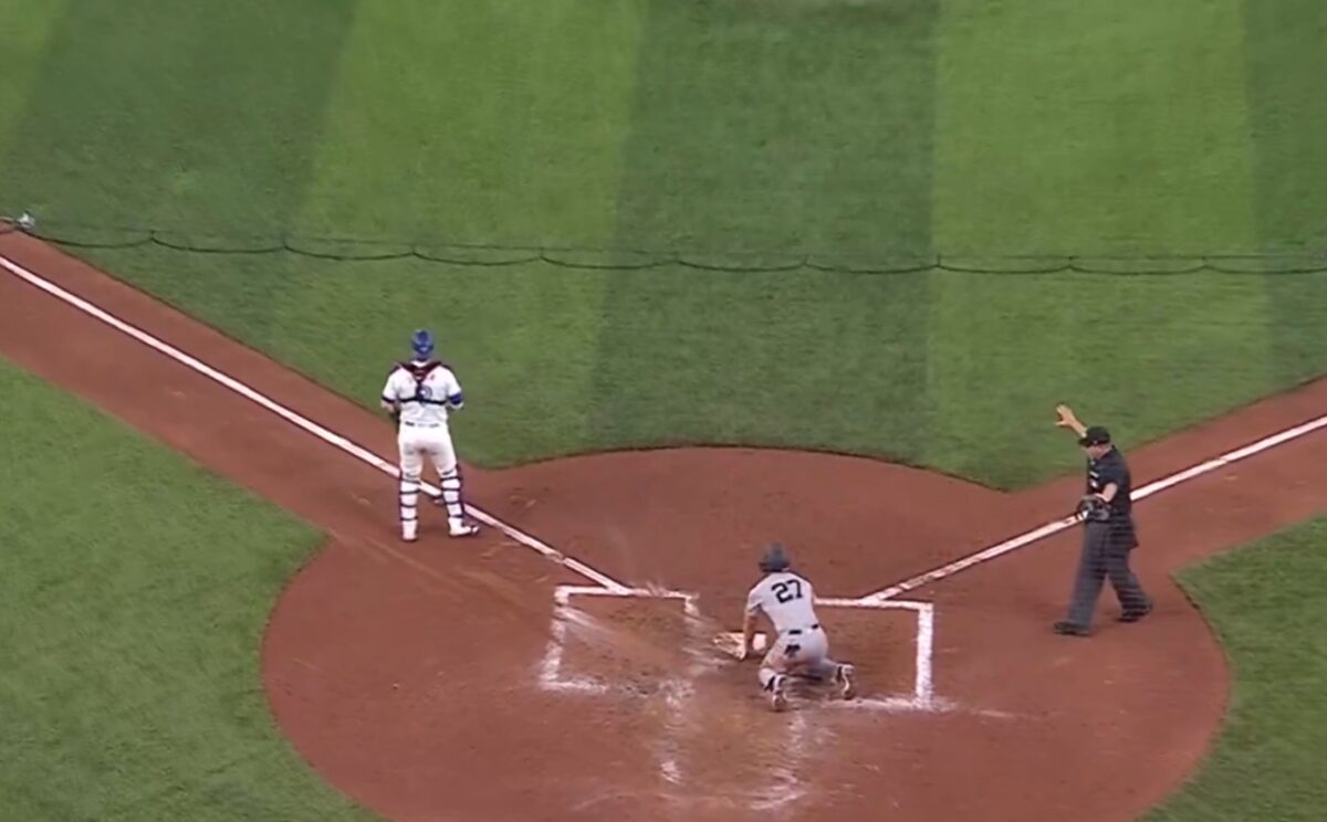 Yankees' Giancarlo Stanton reaches home plate despite sloppy running following an error by the Blue Jays' catcher in Toronto on April 16, 2024. 