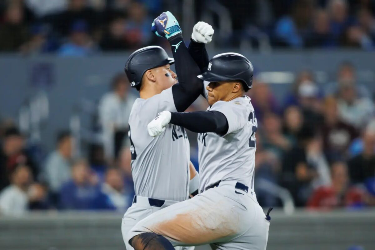 Juan Soto #22 of the New York Yankees celebrates with Aaron Judge #99 on a solo home run in the eighth inning against the Blue Jays on Wednesday.