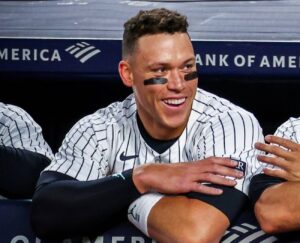 Aaron Judge smiling in the Yankees dugout during a game between the New York Yankees and Toronto Blue Jays on April 4, 2024.