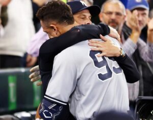 Yankees manager Aaron Boone hugs Aaron Judge after he hit 61st home run on Sept. 28, 2022, at Toronto.