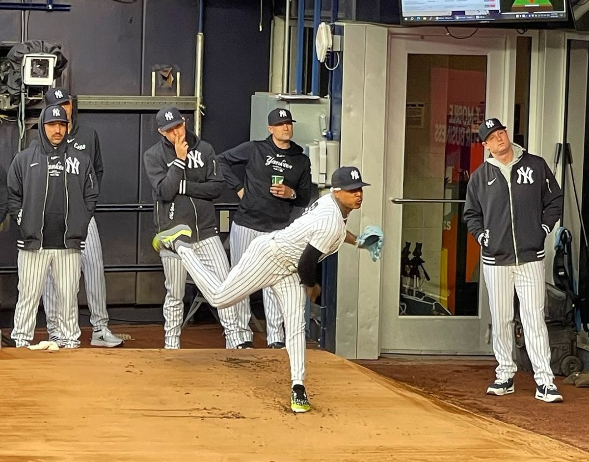 The New York Yankees' rotation members watch as Marcus Stroman pitches during a training session in Tampa on March 20, 2024.