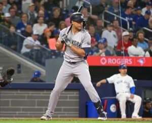 Yankees Giancarlo Stanton takes position before hitting a huge 437-foot home run off Toronto righty Erik Swanson at 111.8 miles per hour at Roger Center on April 17, 2024.