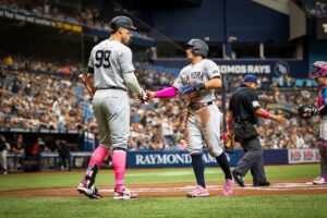 Aaron Judge and Anthony Volpe shake hand after the latter's RBI gave the Yankees a lead over the Rays at Tropicana on May 12, 2024.