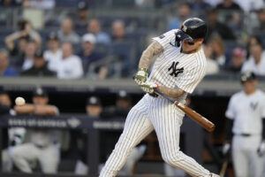 Yankees' Alex Verdugo is hitting a three-run homer off Astros' Verlander at Yankee Stadium on May 7, 2024.