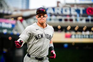 New York Yankees’ Aaron Judge signals to dugout after hitting a home run against the Minnesota Twins during the first inning of a baseball game Wednesday, May 15, 2024, in Minneapolis.