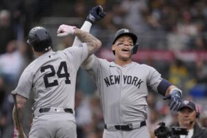 New York Yankees’ Aaron Judge, right, celebrates with teammate Alex Verdugo after hitting a two-run home run during the first inning of a baseball game against the San Diego Padres, Saturday, May 25, 2024, in San Diego.