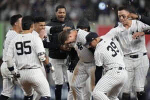 New York Yankees’ Anthony Rizzo, center, celebrates with teammates after hitting a walk-off RBI single during the ninth inning of a baseball game against the Detroit Tigers, Friday, May 3, 2024, in New York. The Yankees won 2-1.