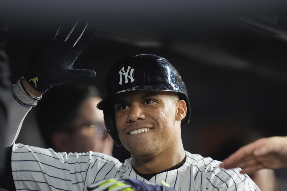 New York Yankees’ Juan Soto smiles in the dugout after hitting a home run against the Seattle Mariners during the sixth inning of a baseball game Wednesday, May 22, 2024, in New York. 
