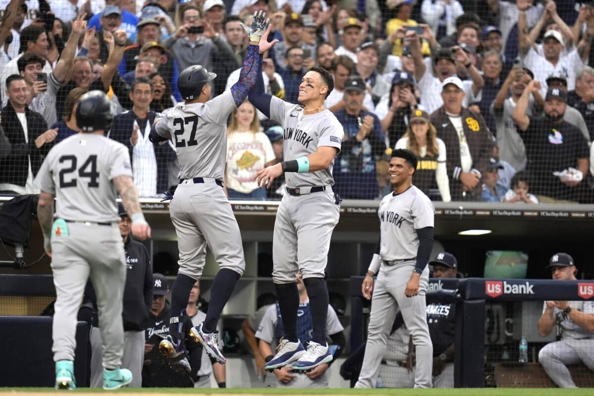 New York Yankees’ Giancarlo Stanton celebrates with teammate Aaron Judge after hitting a two-run home run as Juan Soto looks on during the third inning of a baseball game against the San Diego Padres, May 24, 2024, in San Diego.