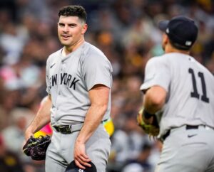 Yankees pitcher Carlos Rodon chats with Anthony Volpe during the game against the Padres on May 24, 2024, in San Diego.