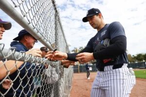 New York Yankees pitcher Tommy Kahnle signs autographs during spring training on February 15, 2024, in Tampa, FL, USA.