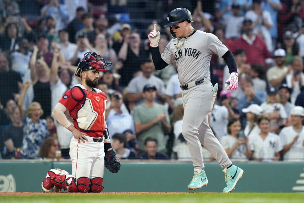 CORRECTS CATCHER TO CONNOR WONG, INSTEAD OF REESE MCGUIRE - New York Yankees’ Alex Verdugo celebrates his two-run home run, next to Boston Red Sox catcher Connor Wong during the first inning of a baseball game Friday, June 14, 2024, in Boston.
