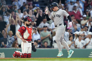 New York Yankees’ Alex Verdugo celebrates his two-run home run, next to Boston Red Sox catcher Connor Wong during the first inning of a baseball game Friday, June 14, 2024, in Boston.