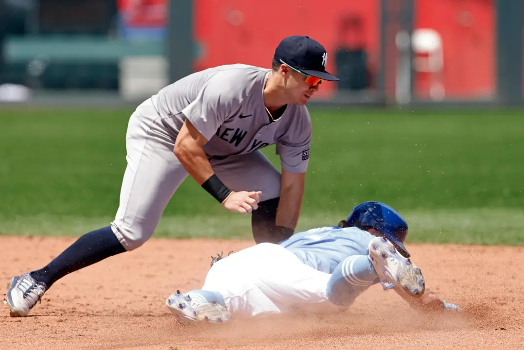 New York Yankees shortstop Anthony Volpe, left, tags out Kansas City Royals’ Bobby Witt Jr., right, as he attempts to steal second base during the sixth inning of a baseball game in Kansas City, Mo., Thursday, June 13, 2024.