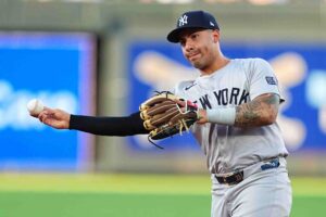 KANSAS CITY, MISSOURI - JUNE 12: Gleyber Torres #25 of the New York Yankees fields a Kansas City Royals infield hit during the first inning at Kauffman Stadium on June 12, 2024 in Kansas City, Missouri.