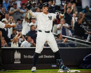 New York Yankees’ Aaron Judge celebrates after reaching third base on a two-run triple against the Minnesota Twins on June 5, 2024, in New York