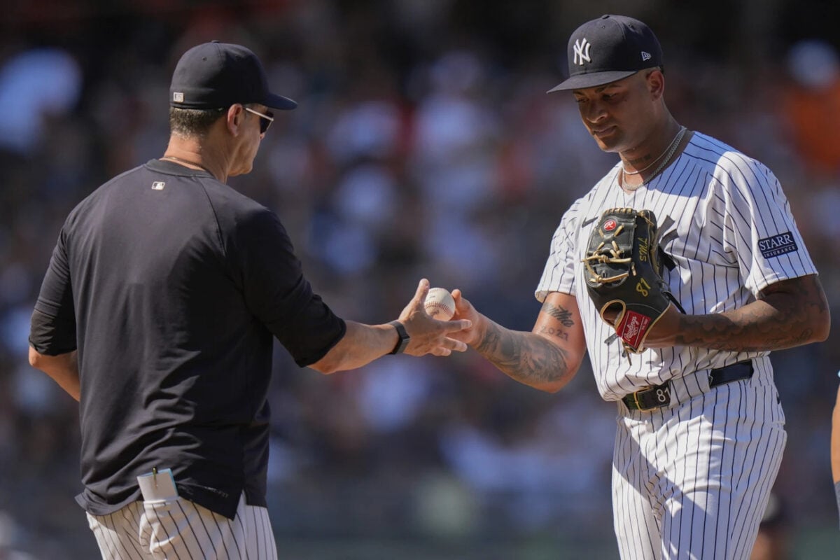 New York Yankees pitcher Luis Gil hands the ball to manager Aaron Boone as he leaves during the second inning of a baseball game against the Baltimore Orioles, Thursday, June 20, 2024, in New York.
