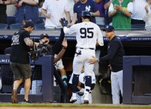 New York Yankees’ Oswaldo Cabrera (95) celebrates at the dugout with manager Aaron Boone, right, and teammates after hitting a home run against the Los Angeles Dodgers during the third inning of a baseball game Sunday, June 9, 2024, in New York.