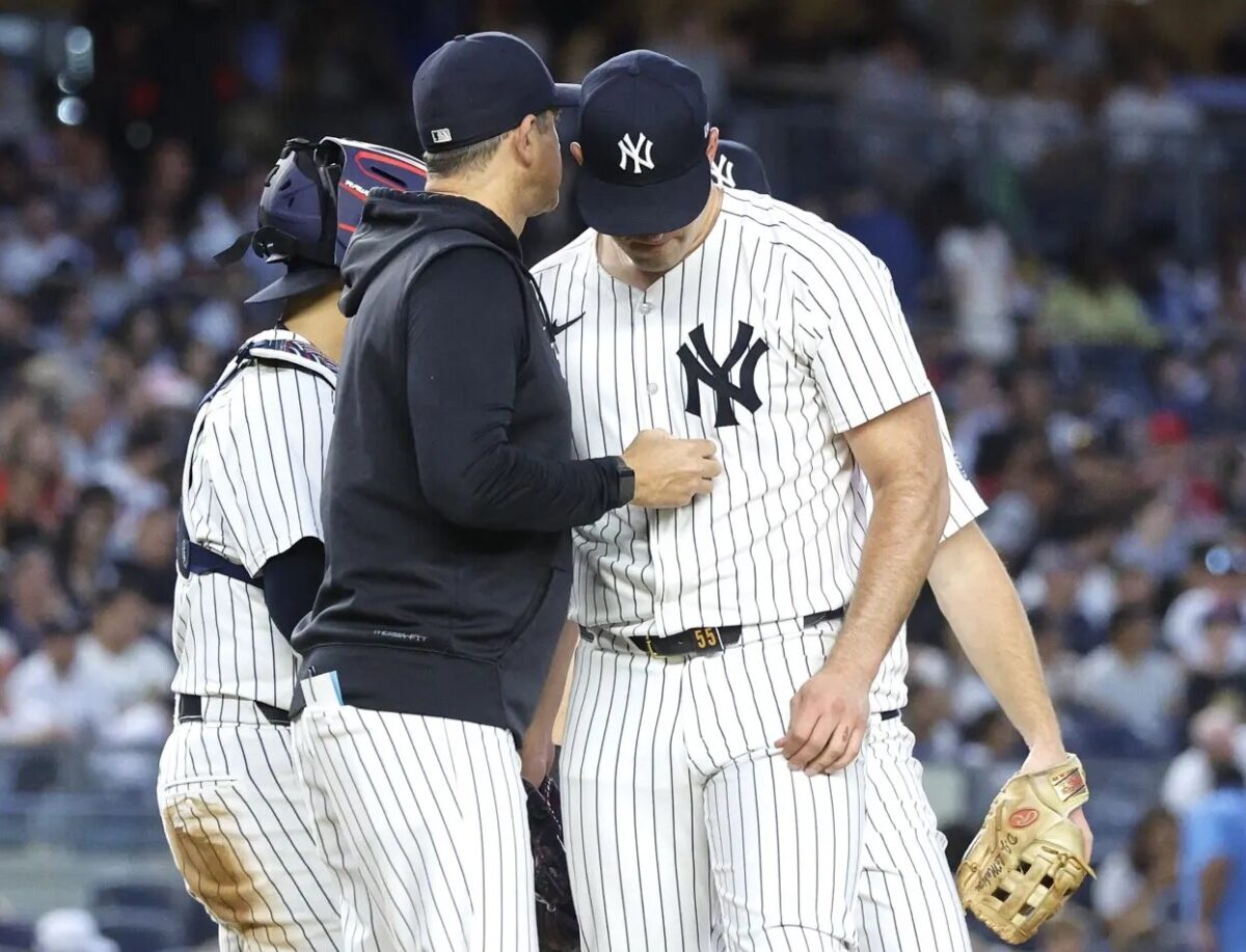 Aaron Boone concinces Yankees pitcher Carlos Rodon to end his outing against the Reds at Yankee Stadium on July 3, 2024.