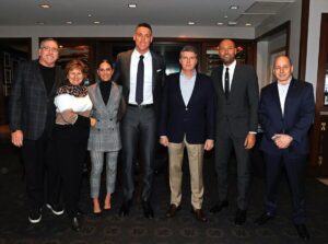 Aaron Judge and his family pose with Yankees owner Hal Steinbrenner and Derek Jeter as he signed the $360 million contract in 2023.