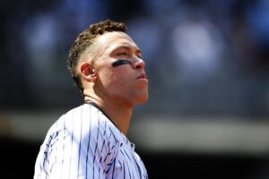 New York Yankees’ Aaron Judge (99) looks out from the dugout during the seventh inning inning of a baseball game against the Tampa Bay Rays, Saturday, April 20, 2024 in New York.