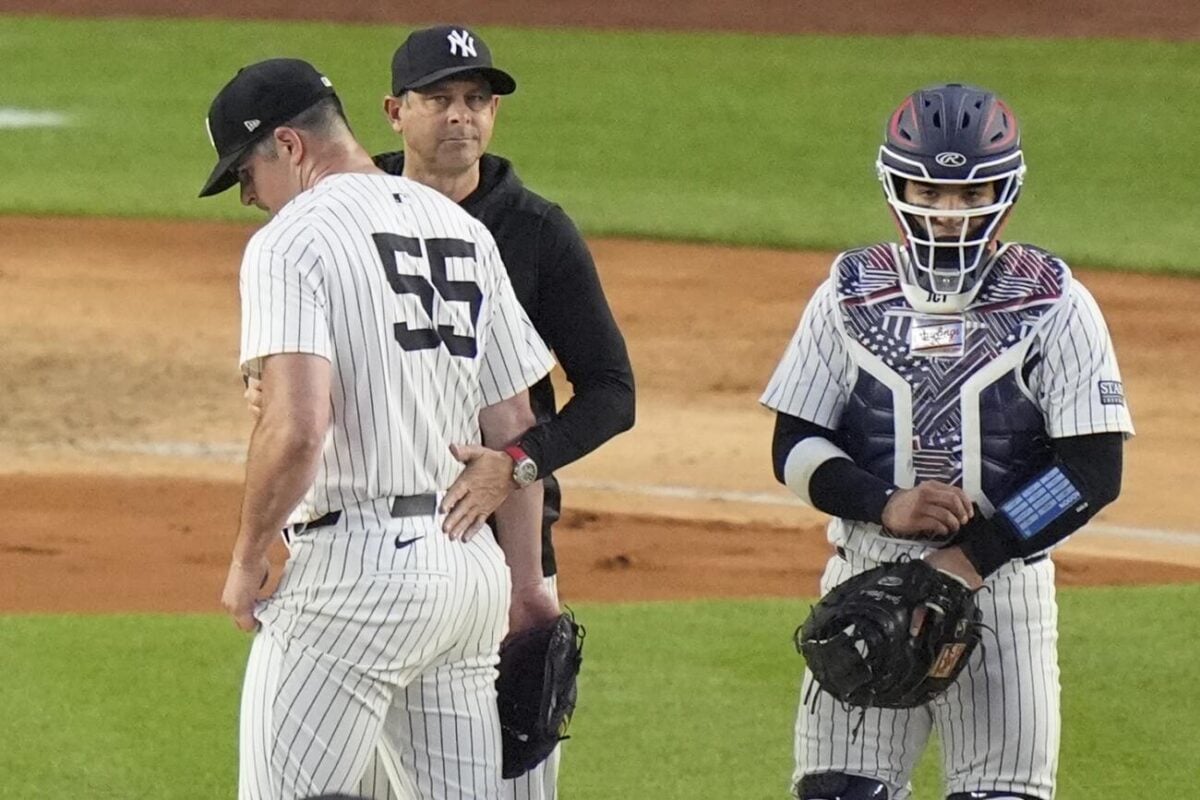 New York Yankees catcher Jose Trevino, right, watches as manager Aaron Boone takes pitcher Carlos Rodón, left, out of the game during the sixth inning of a baseball game against the Cincinnati Reds, Wednesday, July 3, 2024, in New York.
