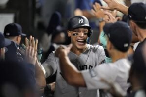 New York Yankees designated hitter Aaron Judge celebrates after hitting his 300th career home run, the fastest player to do so in MLB history, during the eighth inning of a baseball game against the Chicago White Sox, Wednesday, Aug. 14, 2024, in Chicago.