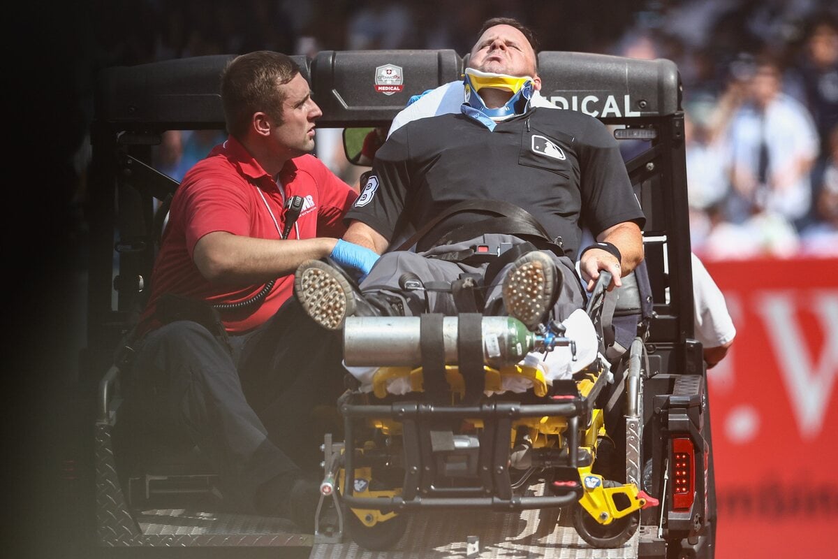 Home plate umpire Nick Mahrley (48) is carted off the field after getting hit by a broken bat in the fifth inning during the game between Colorado Rockies and New York Yankees at Yankee Stadium.