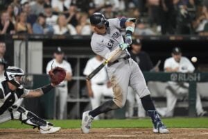 New York Yankees' Aaron Judge hits his 300th career home run, the fastest playing in MLB history to do so, during the eighth inning of a baseball game against the Chicago White Sox, Wednesday, Aug. 14, 2024, in Chicago.