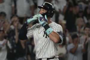 New York Yankees’ Aaron Judge celebrates after hitting a home run which also scored Juan Soto during the first inning of a baseball game against the Toronto Blue Jays, Friday, Aug. 2, 2024, in New York.