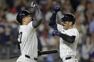 New York Yankees’ Austin Wells is congratulated by Giancarlo Stanton, left, after hitting a two-run home run during the eighth inning of a baseball game against the St. Louis Cardinals, Friday, Aug. 30, 2024, in New York. The Yankees won 6-3.