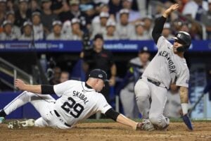 New York Yankees’ Gleyber Torres, right, scores on a wild pitch by Detroit Tigers starter Tarik Skubal (29) during the sixth inning of the Little League Classic baseball game at Bowman Field in Williamsport, Pa., Sunday, Aug. 18, 2024.