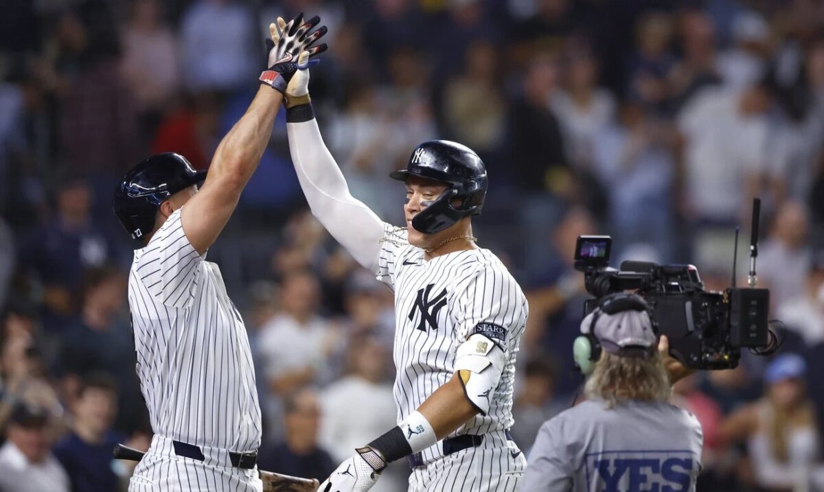 New York Yankees’ Aaron Judge, center, celebrates with Giancarlo Stanton, left, after hitting a home run against the Baltimore Orioles during the seventh inning of a baseball game, Thursday, Sept. 26, 2024, in New York. 