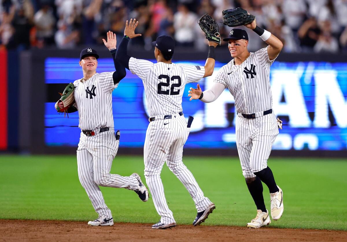 New York Yankees’ Alex Verdugo, Juan Soto and Aaron Judge celebrate after clinching the American League East title.