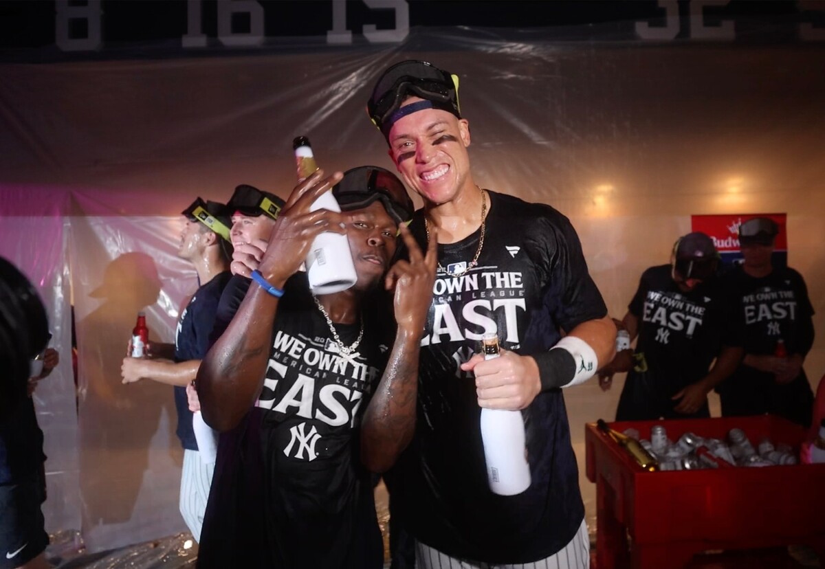 New York Yankees third baseman Jazz Chisholm Jr. and center fielder Aaron Judge pose in the clubhouse after defeating the Baltimore Orioles.