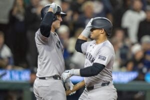 New York Yankees’ Jasson Dominguez, right, celebrates with Anthony Rizzo after hitting a solo home run during the fifth inning of a baseball game against the Seattle Mariners, Tuesday, Sept. 17, 2024, in Seattle.