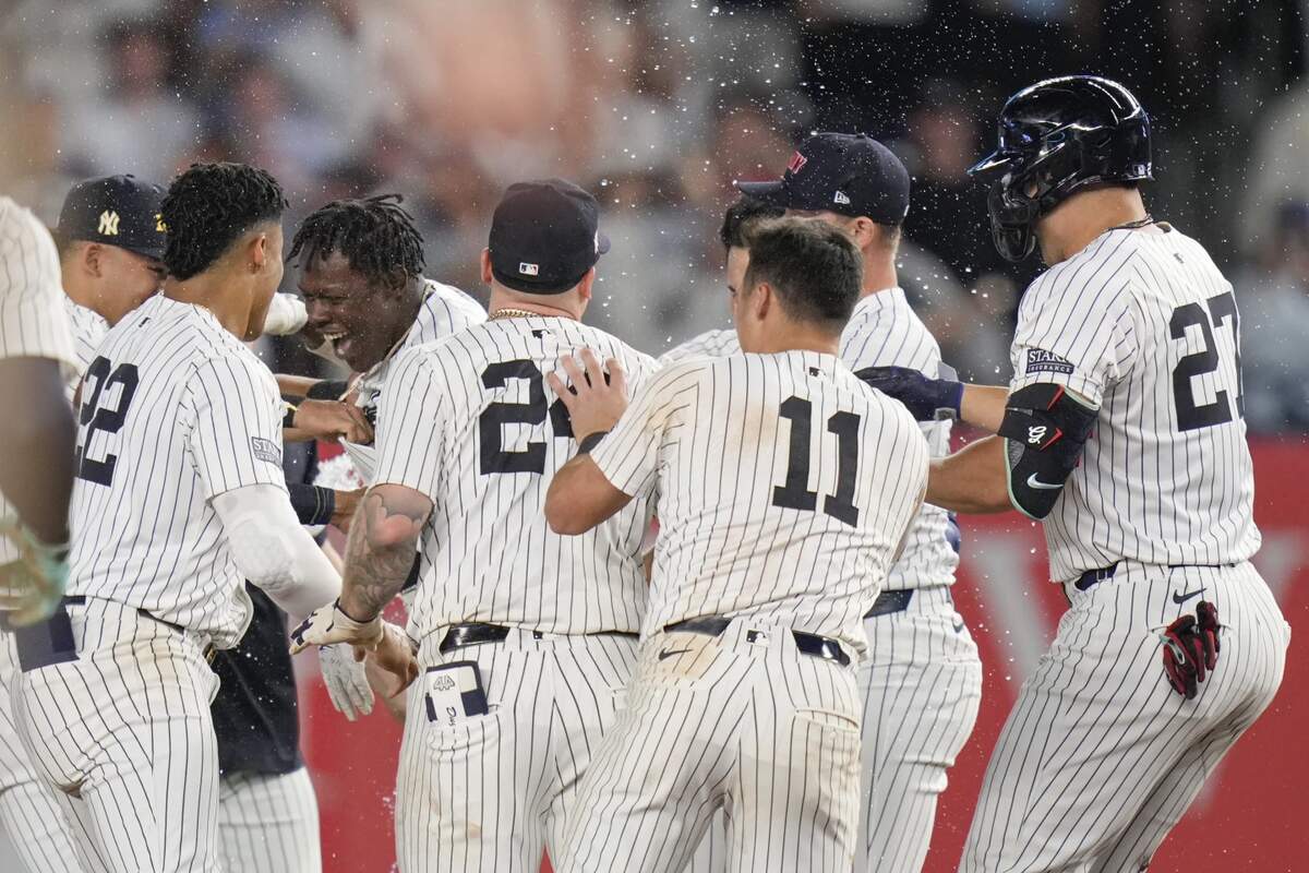 New York Yankees’ Jazz Chisholm Jr., center left, celebrates with teammates after hitting a walk-off RBI single during the 11th inning of a baseball game against the Kansas City Royals at Yankee Stadium, Wednesday, Sept. 11, 2024, in New York.