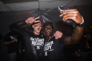 New York Yankees first baseman Anthony Rizzo, left, poses for a photo with third baseman Jazz Chisholm Jr., right, as they celebrate clinching a playoff spot after a 2-1 win in 10 innings over the Seattle Mariners in a baseball game Wednesday, Sept. 18, 2024, in Seattle.