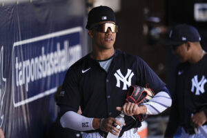 New York Yankees right fielder Juan Soto stands in the dugout before a spring training baseball game against the Boston Red Sox Wednesday, March 13, 2024, in Tampa, Fla.