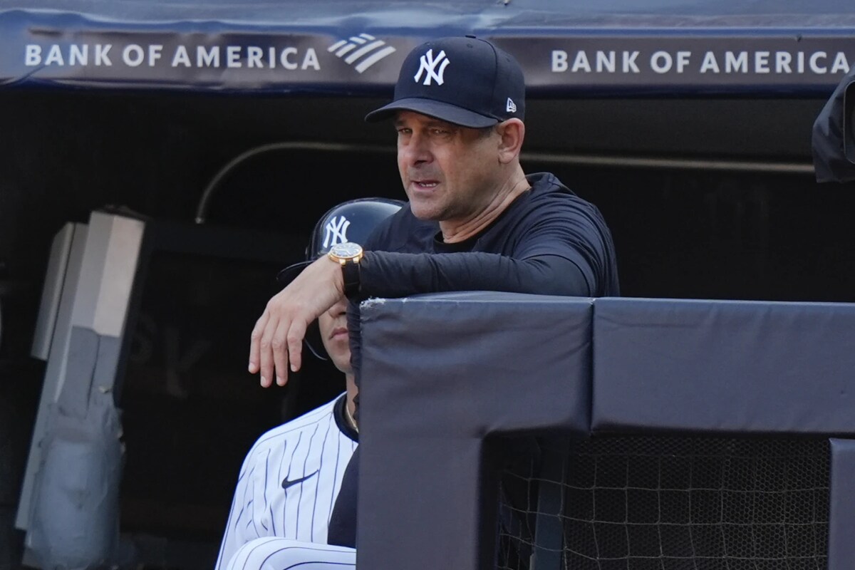 New York Yankees manager Aaron Boone watches from the dugout steps during the ninth inning of a baseball game against the Boston Red Sox, Saturday, Sept. 14, 2024, in New York. The Red Sox won 7-1. 