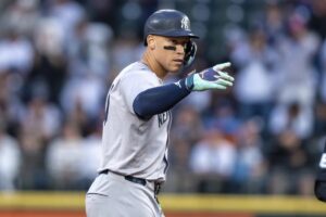 New York Yankees’ Aaron Judge gestures to the dugout after hitting a two-run double during the first inning of a baseball game against the Seattle Mariners, Tuesday, Sept. 17, 2024, in Seattle.