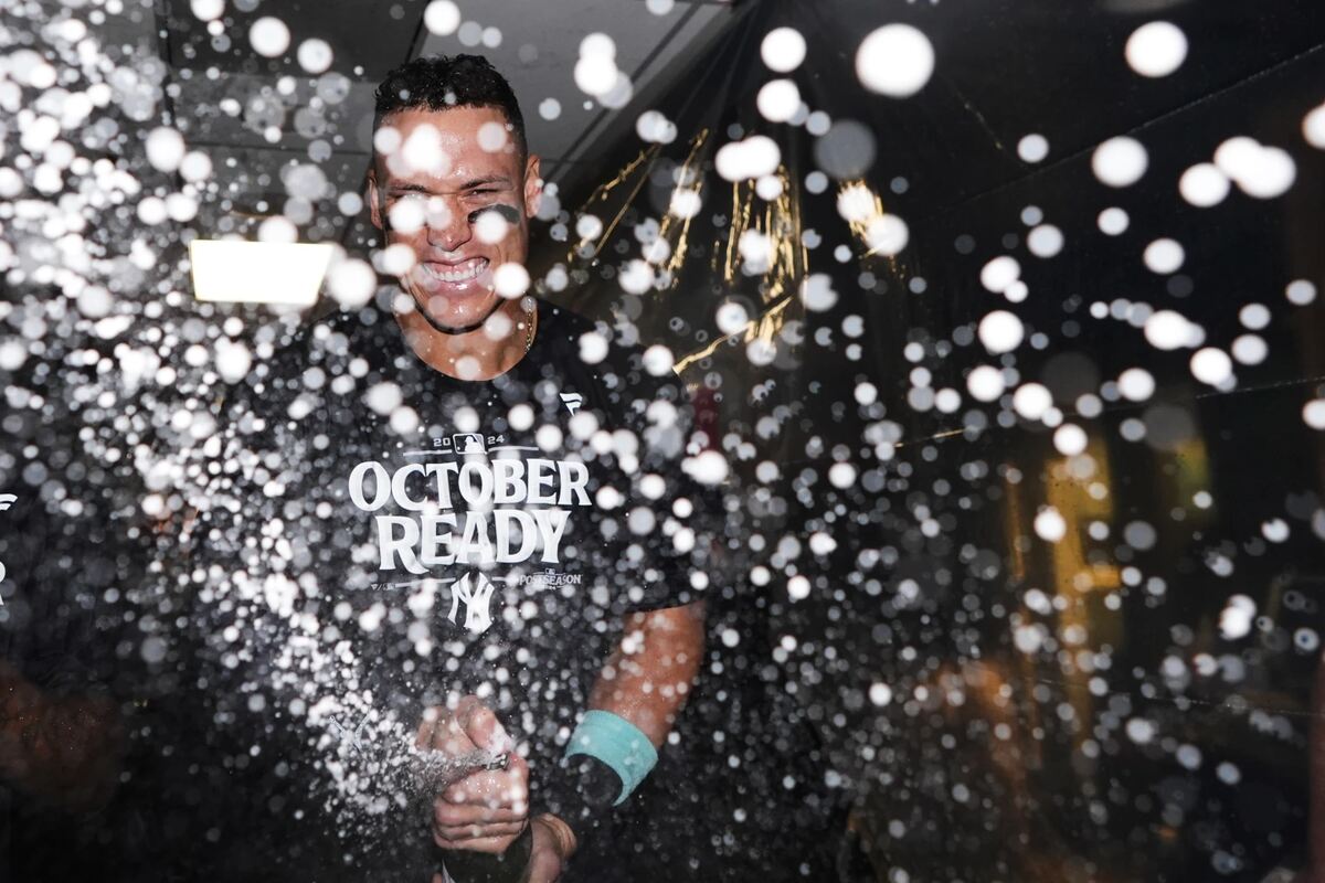 New York Yankees’ Aaron Judge celebrates clinching a playoff spot after a 2-1 win in 10 innings over the Seattle Mariners in a baseball game Wednesday, Sept. 18, 2024, in Seattle.