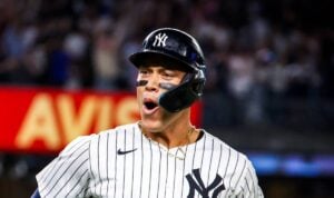 Aaron Judge hits a go-ahead grand slam for his 52nd home run, while Yankees fans celebrate. Luke Weaver records the save in a crucial 5-4 win against the Red Sox, extending the Yankees' AL East lead.