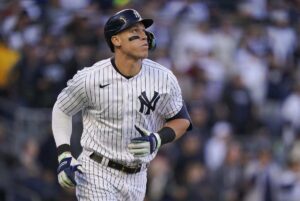 Aaron Judge of the New York Yankees stands poised at home plate, mid-swing, after a period of struggle in August and September